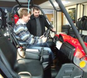 how to buy a utv, Jason Lannon left owner of M F Motors in Stephenville Nfld shows potential buyer Bill Oliver the features on the Yamaha Rhino