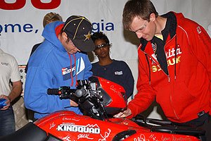 suzuki plant celebrates milestone, Team Suzuki s Doug Gust and Ryan Cox sign the historic KingQuad 450