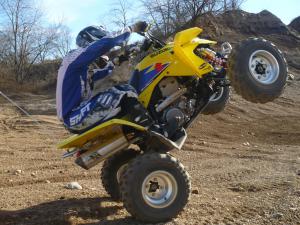 2009 suzuki quadsport z400 review, Throttle response is much improved and it s very easy to get the front wheels off the ground