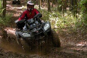 2010 kymco mxu 500 irs 44 le review, A muddy rutted out off camber trail was no trouble for the MXU 500