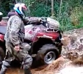 guy walks his 44 atv over an obstacle video