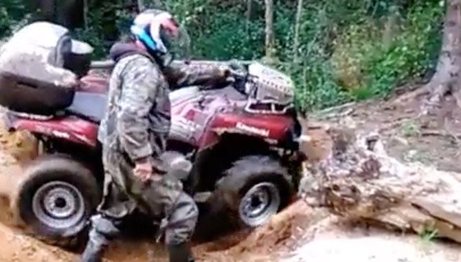 guy walks his 44 atv over an obstacle video