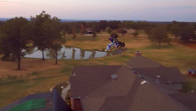 atv rider backflips over a house video