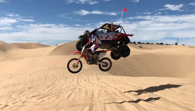 this utv driver sails past this dirtbike rider in mid air video