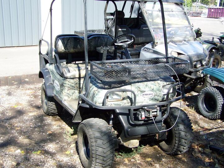 camo with racks roof off road tires seats four electric motor touring