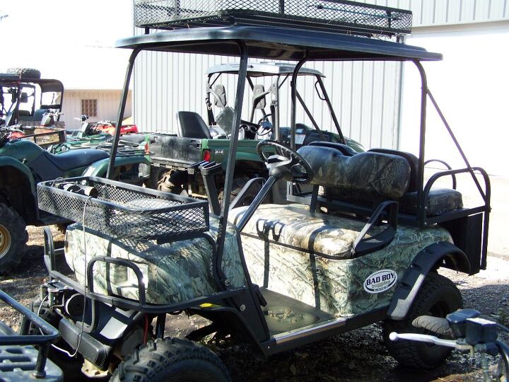 camo with racks roof off road tires seats four electric motor touring